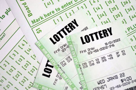 Green lottery tickets and blank bills with numbers for playing lottery close up