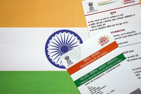 Indian Aadhaar card from Unique Identification Authority of India on Indian flag close up