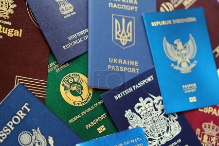 Many various passports of citizens of different countries and regions of the world close up