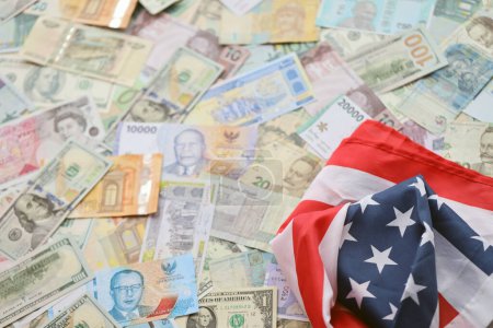 United States flag on many banknotes of different currency. Background of war funding and military support price for United States of America