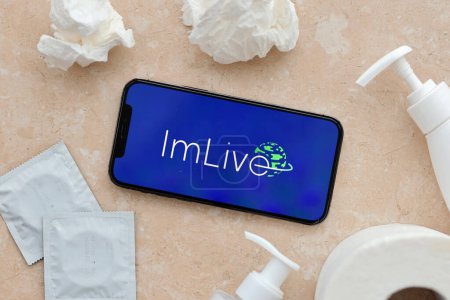 Photo for KYIV, UKRAINE - JANUARY 23, 2024 ImLive adult content website logo on display of iPhone 12 Pro smartphone - Royalty Free Image