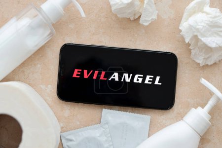 Photo for KYIV, UKRAINE - JANUARY 23, 2024 EvilAngel adult content website logo on display of iPhone 12 Pro smartphone - Royalty Free Image