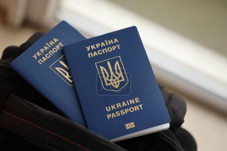 Photo for Two ukrainian biometrical passports on black touristic backpack close up - Royalty Free Image