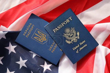Photo for United States of America and Ukrainian Passports on folded US flag close up - Royalty Free Image