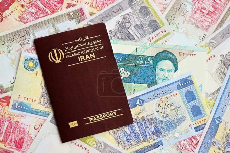 Photo for Red Islamic Republic of Iran passport and iranian reals money bills background close up. Tourism and travel concept - Royalty Free Image