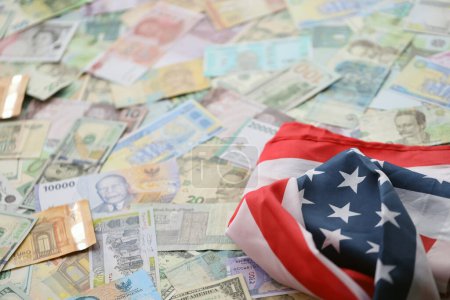United States flag on many banknotes of different currency. Background of war funding and military support price for United States of America