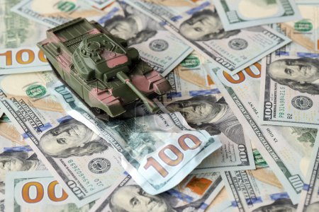 Tank on crumpled hundred dollar bills banknotes. Background of war funding and military support price for United States of America