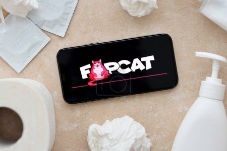Photo for KYIV, UKRAINE - JANUARY 23, 2024 FapCat adult content website logo on display of iPhone 12 Pro smartphone - Royalty Free Image