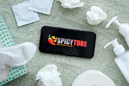 Photo for KYIV, UKRAINE - JANUARY 23, 2024 SpicyTube adult content website logo on display of iPhone 12 Pro smartphone - Royalty Free Image
