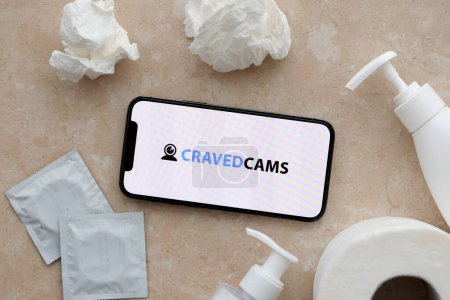 Foto de KYIV, UCRANIA - 23 de enero de 2024 CravedCams logotipo del sitio web de contenido para adultos en la pantalla del teléfono inteligente iPhone 12 Pro - Imagen libre de derechos