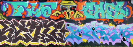 Photo for The old wall decorated with paint stains in the style of street art culture. Colorful background of full graffiti painting artwork with bright aerosol outlines on wall. Colored background texture - Royalty Free Image