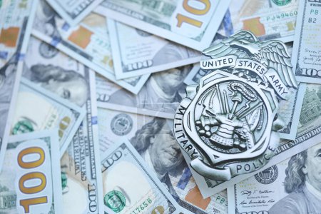 Foto de KYIV, UCRANIA - 9 de marzo de 2024 La insignia de la Policía Militar del Ejército de los Estados Unidos en muchos billetes de cien dólares estadounidenses se cierra - Imagen libre de derechos