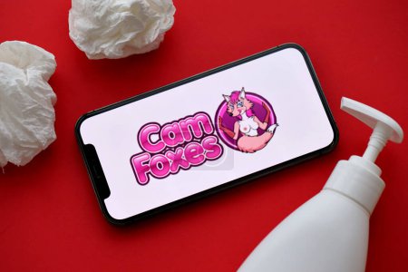 Photo for KYIV, UKRAINE - JANUARY 23, 2024 CamFoxes adult content website logo on display of iPhone 12 Pro smartphone - Royalty Free Image
