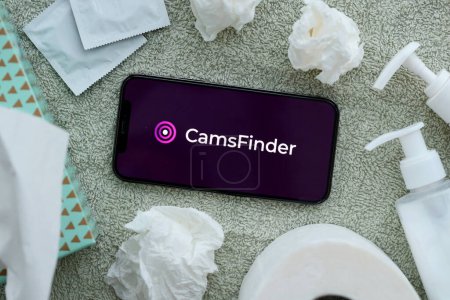 Photo for KYIV, UKRAINE - JANUARY 23, 2024 CamsFinder adult content website logo on display of iPhone 12 Pro smartphone - Royalty Free Image