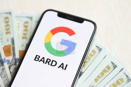 Photo for KYIV, UKRAINE - MARCH 17, 2024 Google Bard logo on iPhone display screen with many hundred dollar bills. Artificial Intelligence engine - Royalty Free Image