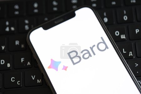 Photo for KYIV, UKRAINE - MARCH 17, 2024 Google Bard logo on iPhone display screen and MacBook keyboard. Artificial Intelligence engine - Royalty Free Image