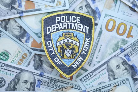 Foto de KYIV, UCRANIA - 9 de marzo de 2024 US NYPD Police patch on many US hundred dollar bills close up - Imagen libre de derechos