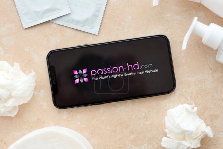 Photo for KYIV, UKRAINE - JANUARY 23, 2024 PassionHD adult content website logo on display of iPhone 12 Pro smartphone - Royalty Free Image