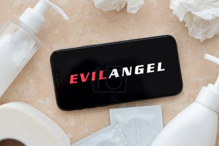 Photo for KYIV, UKRAINE - JANUARY 23, 2024 EvilAngel adult content website logo on display of iPhone 12 Pro smartphone - Royalty Free Image