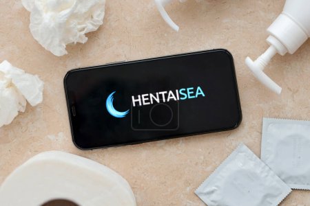 Photo for KYIV, UKRAINE - JANUARY 23, 2024 HentaiSea adult content website logo on display of iPhone 12 Pro smartphone - Royalty Free Image