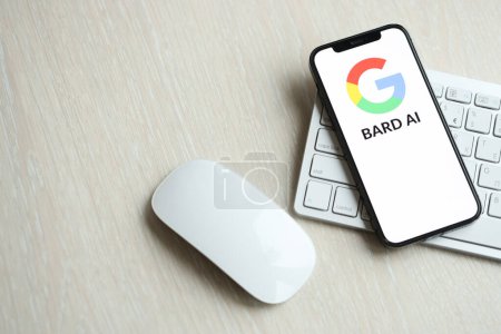 Photo for KYIV, UKRAINE - MARCH 17, 2024 Google Bard logo on iPhone display screen with apple keyboard and mouse on table. Artificial Intelligence engine - Royalty Free Image