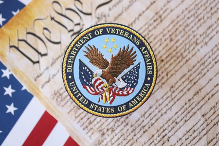 Photo for KYIV, UKRAINE - MARCH 9, 2024 US Department of Veteran Affairs seal with United States Constitution on flag close up - Royalty Free Image