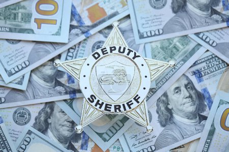 Foto de KYIV, UCRANIA - 9 de marzo de 2024 Insignia del Sheriff Adjunto de los Estados Unidos en muchos billetes de cien dólares de primer plano - Imagen libre de derechos