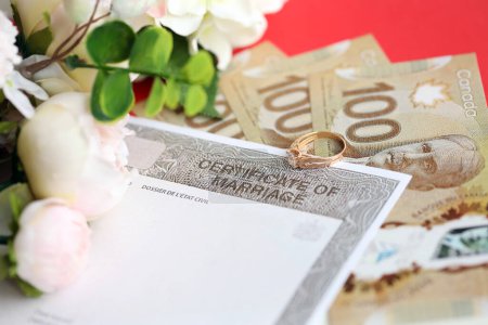 Certificat canadien d'enregistrement de mariage document vierge et alliance avec dollars canadiens gros plan