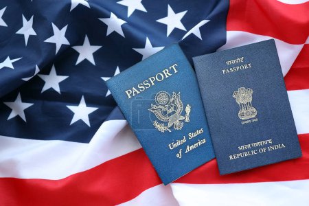Passport of India with US Passport on United States of America folded flag close up