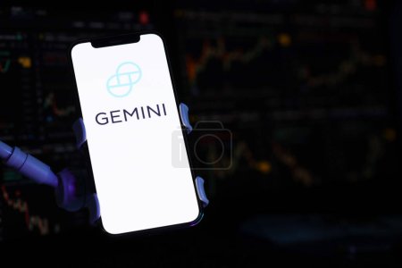 Photo for KYIV, UKRAINE - MARCH 15, 2024 Gemini logo on iPhone display screen and crypto currency value charts. Cryptocurrency exchange portal - Royalty Free Image