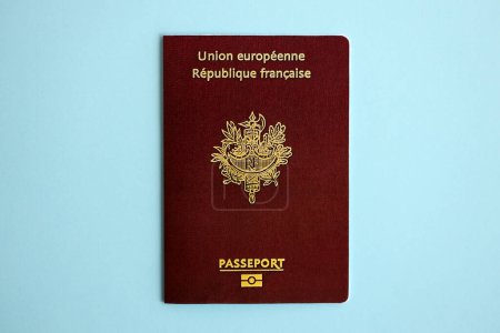 French passport on blue background close up. Tourism and citizenship concept
