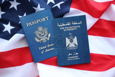 Passport of Palestinian Authority with US Passport on United States of America folded flag close up