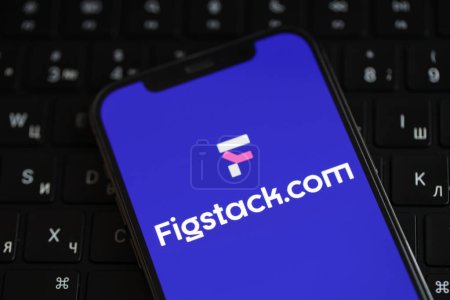 Photo for KYIV, UKRAINE - MARCH 17, 2024 Figstack logo on iPhone display screen and MacBook keyboard. Artificial Intelligence engine - Royalty Free Image