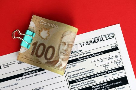 T1 canadienne Formulaire général d'impôt La déclaration de revenus et de prestations se trouve sur la table avec la fermeture des bons de paiement canadiens. Fiscalité et comptabilité annuelle au Canada