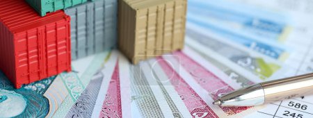Global business container cargo ship in import export business logistic. Company shipping and logistics in Iran with rials money bills and pen close up