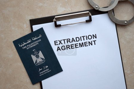 Passport of Palestinian Authority and Extradition Agreement with handcuffs on table close up