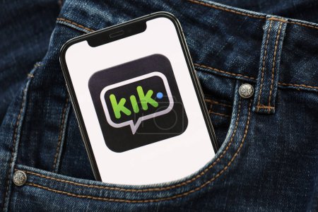 Photo for KYIV, UKRAINE - APRIL 1, 2024 Kik messenger icon on smartphone display screen in jeans pocket. iPhone display with app logo hide in fashionable denims pocket close up - Royalty Free Image