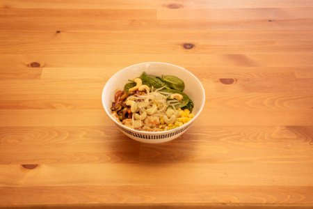 Photo for A wonderful bowl of vegan salad with bean sprouts, cashew nuts, corn and spinach - Royalty Free Image
