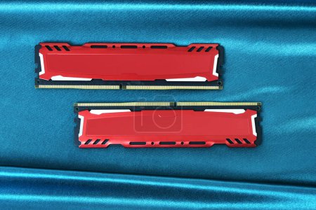 Photo for Two ddr4 ram memory modules with red metal diffusers on a shiny green cloth surface - Royalty Free Image