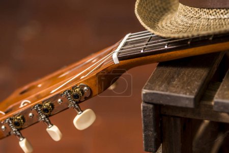 Photo for The fret of a ukulele with its strings on a wooden table - Royalty Free Image