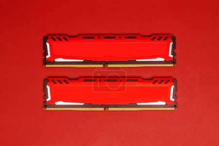 Photo for Ddr4 ram memory cards with red aluminum heat sinks on a matching color surface - Royalty Free Image
