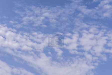 Téléchargez les photos : Un ciel bleu avec des nuages duveteux par une journée chaude - en image libre de droit