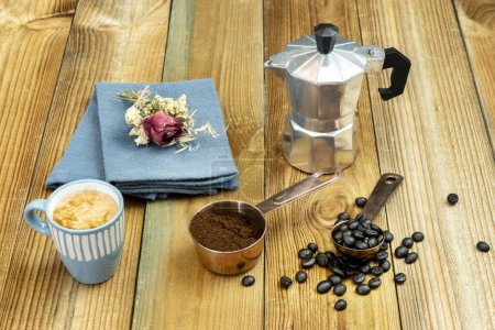 Photo for Coffee still life with coffee pot, dispenser with ground coffee, a cup with espresso and roasted coffee beans - Royalty Free Image