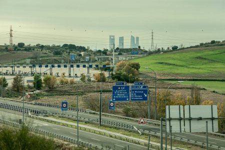 Access highway to the northern area of Madrid, toll booths and with the area of the four towers in the background (although there are five of them)
