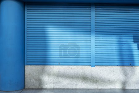 Blue metal blinds with security closure in a premises on the ground floor of an office building