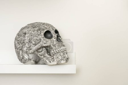 A white skull with bas-relief drawings on the surface