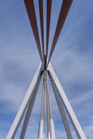 Suspension cables and structure of a small suspension bridge with a metal structure over a road