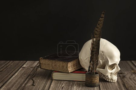a white skull with teeth next to some books and a pen with ink