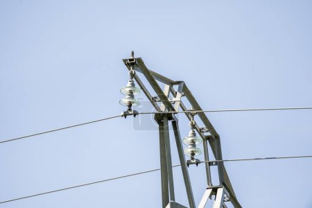 High voltage metal tower with glass insulators supporting the cables
