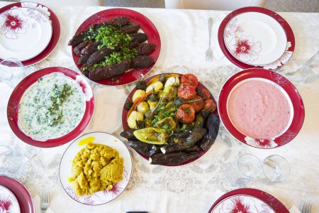 A variety of vegetarian dishes on the plates on the table.
